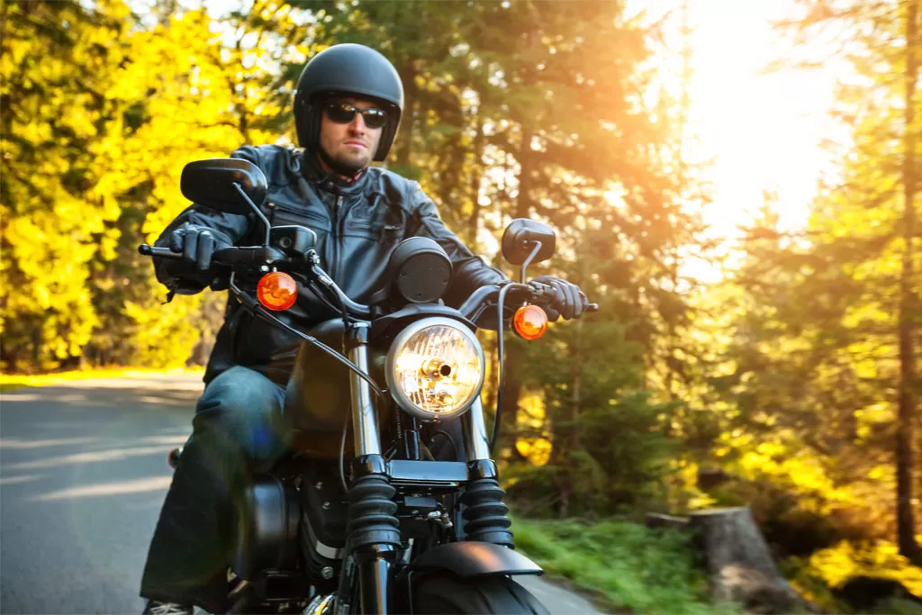 A man enjoys riding a bike on a sunny day that he financed with a credit union motorcycle loan.