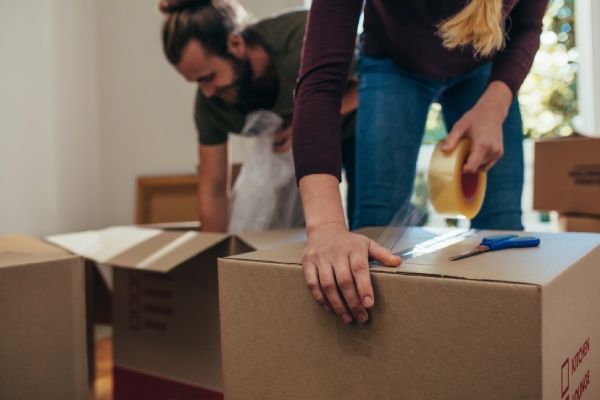 A couple pack away items after an elder relative's passing
