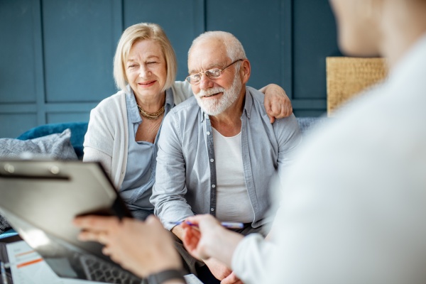 An older couple work with a retirement planning advisor