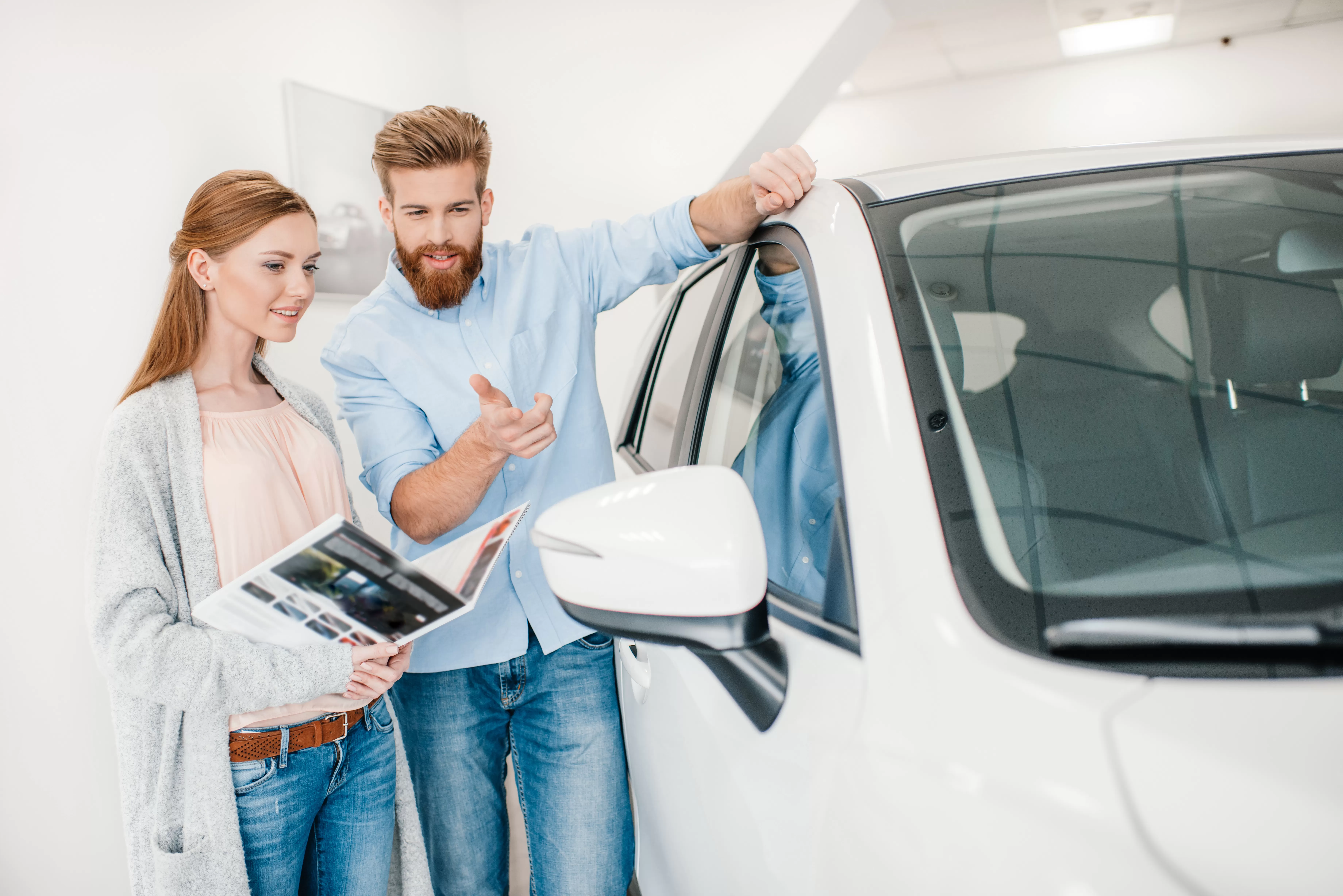 After learning how to get pre-approved for a car loan, a couple goes car shopping at a dealership.